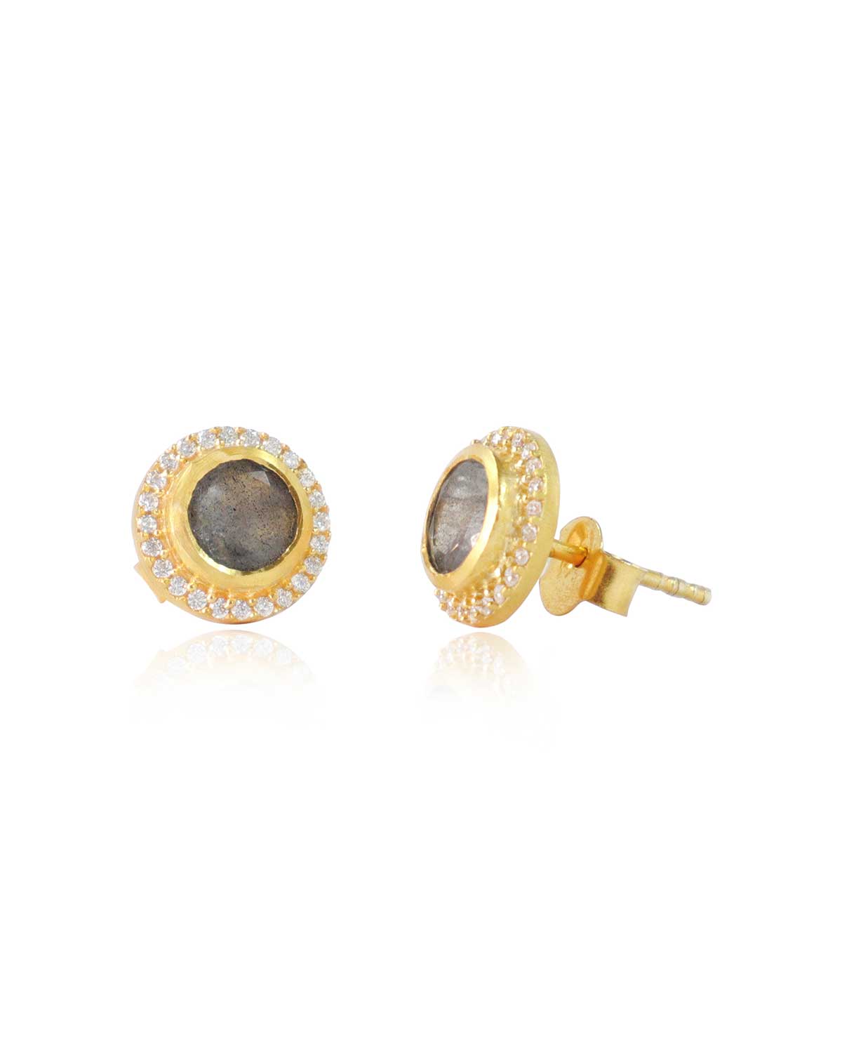 Close-up of gold stud earrings with moonstone centre and crystal details