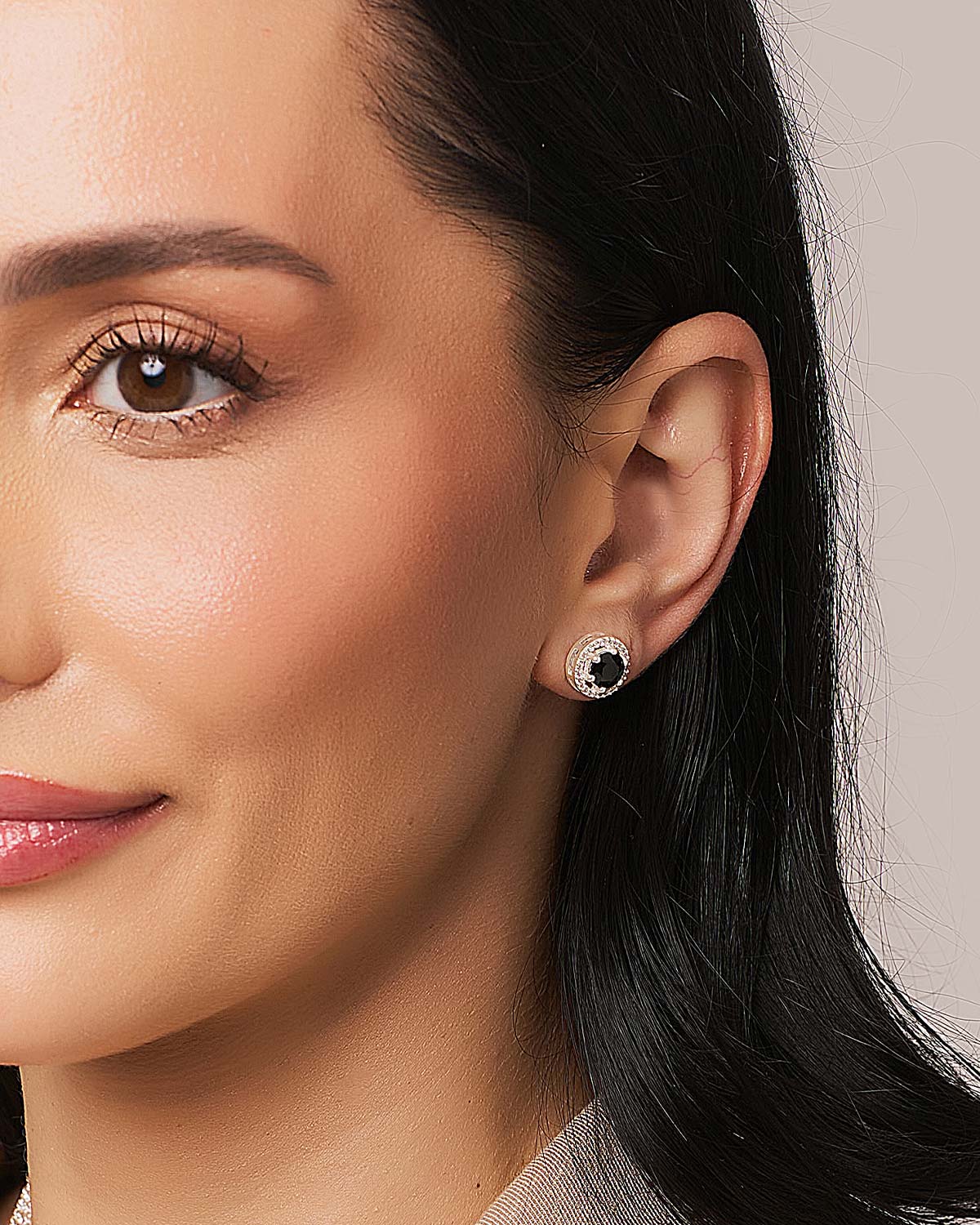 Model wearing sterling silver stud earrings with natural gemstones