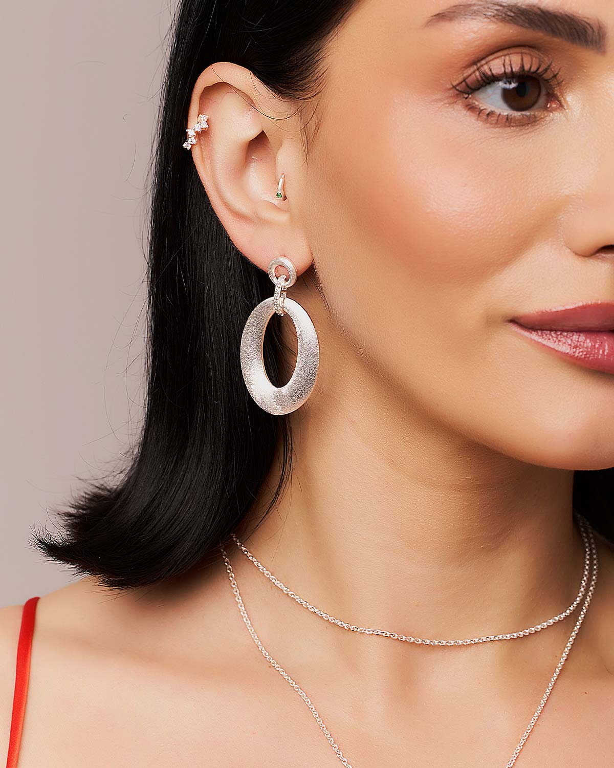 Model wearing sterling silver earrings with sparkling moissanite diamonds