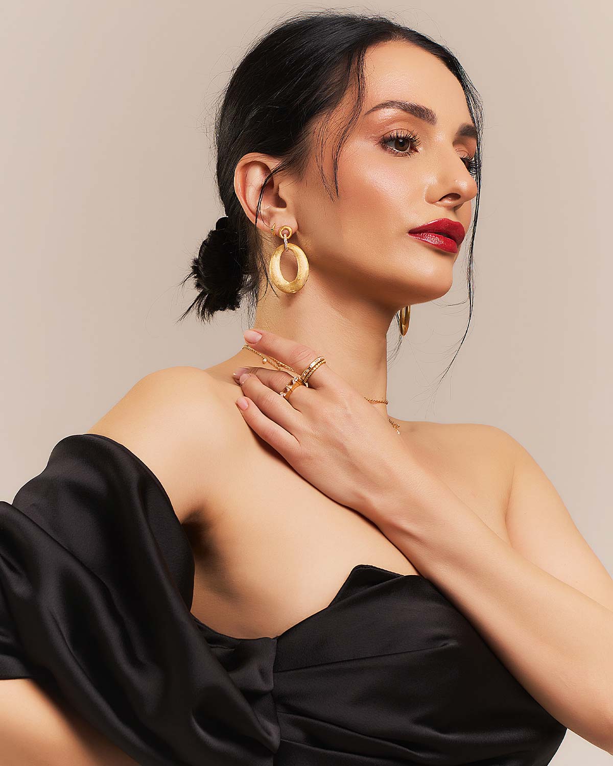 Close-up of gold earrings showcasing 18 white diamonds and intricate detailing