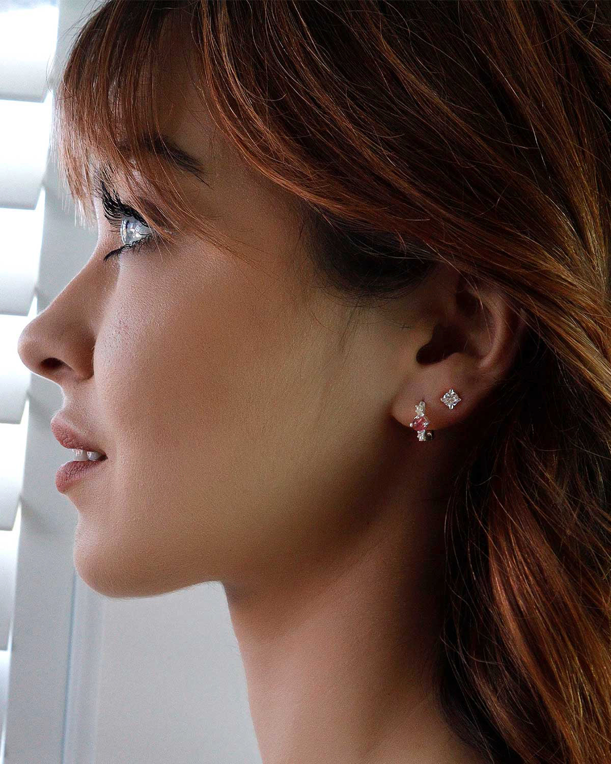 Side angle of silver mini hoops with tourmaline gemstones and pearls