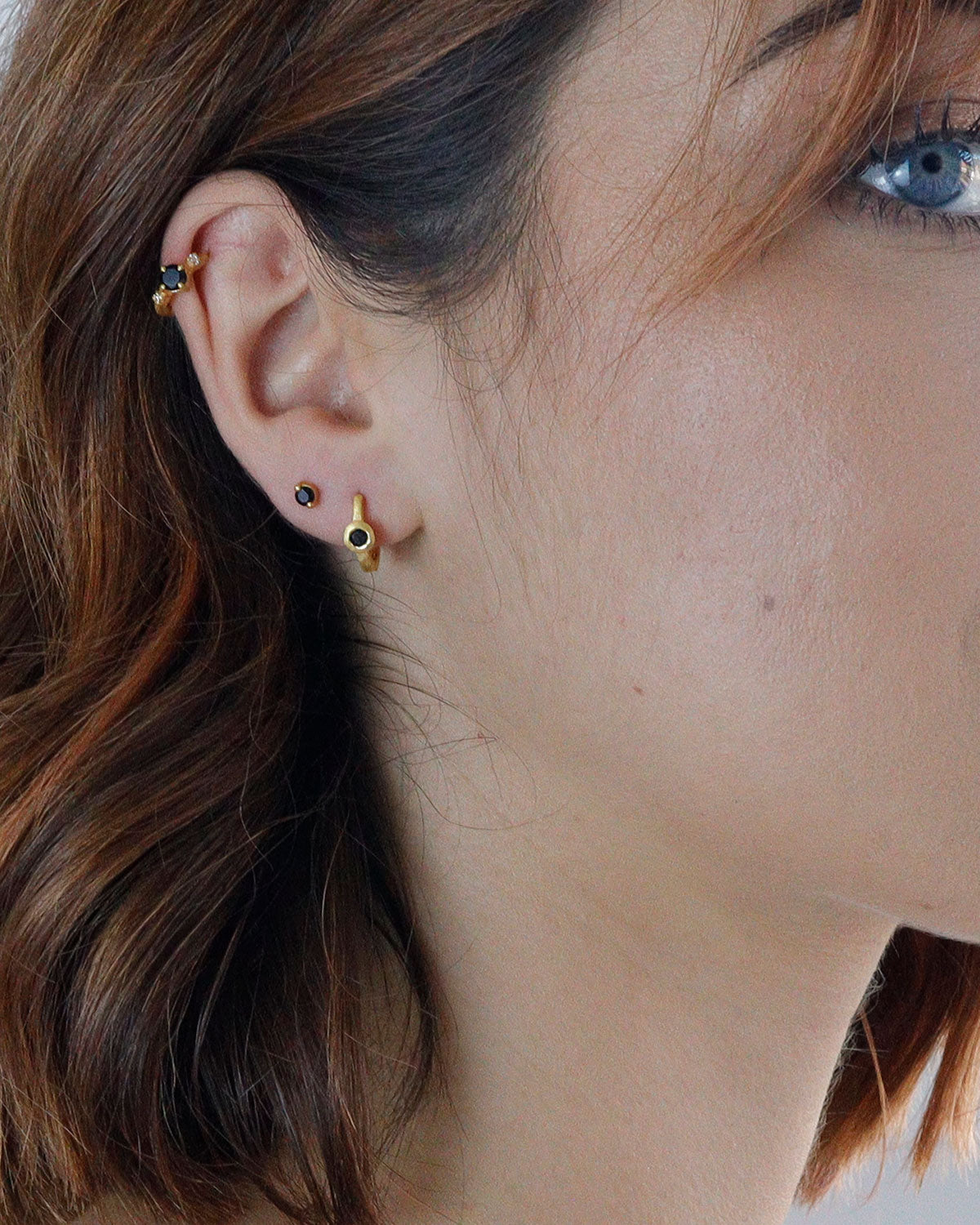 Lightweight gold mini hoops with black spinel gemstones for everyday wear