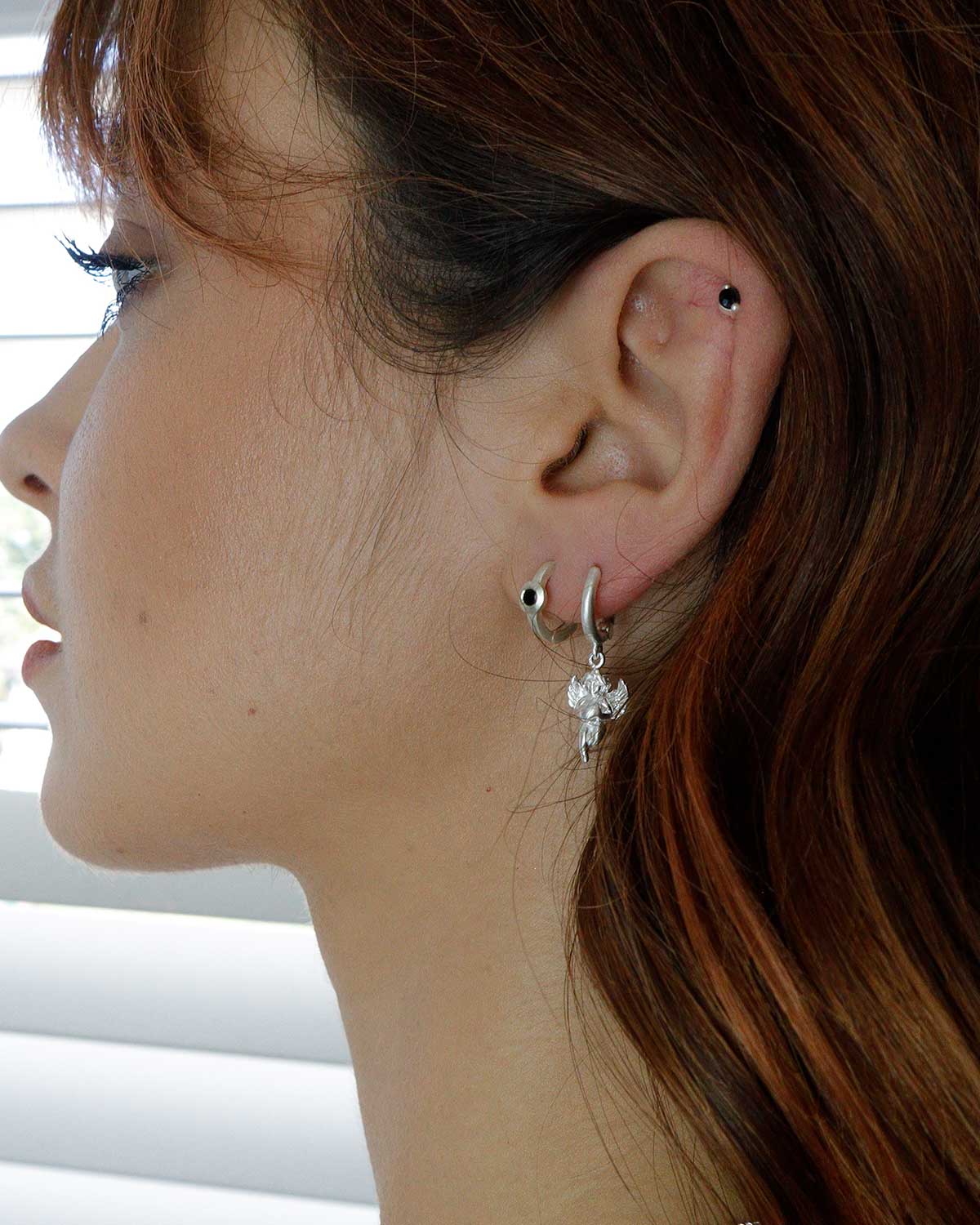 Lightweight silver mini hoop earrings with black spinel gemstones