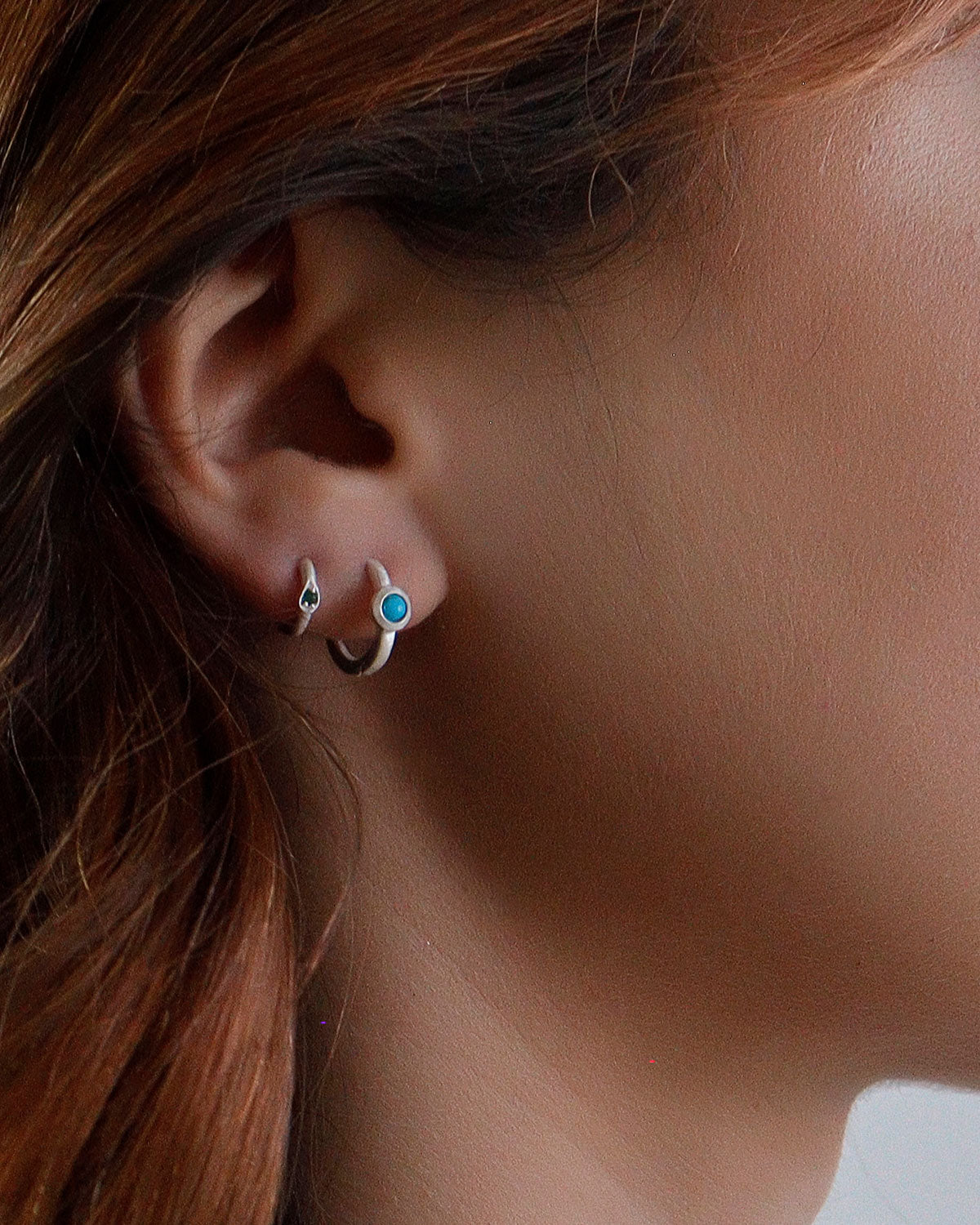 Side angle of silver mini hoops with turquoise gemstones