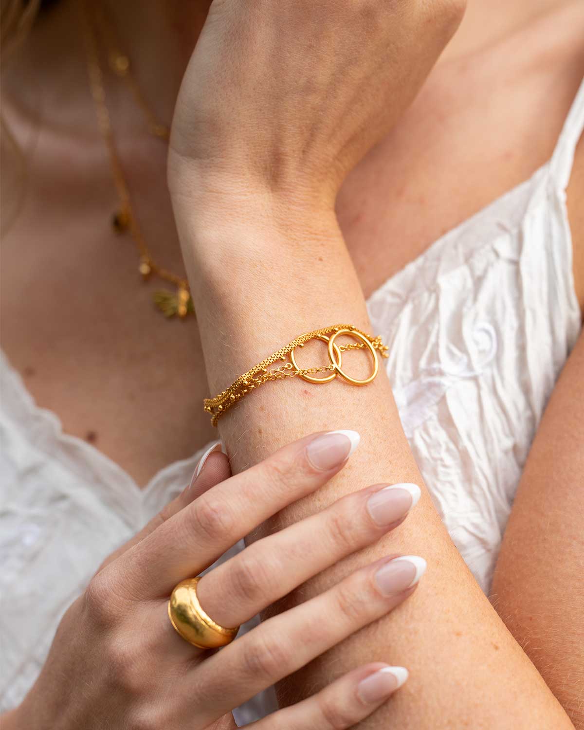 Close-up of a gold adjustable bracelet with two different-sized circles