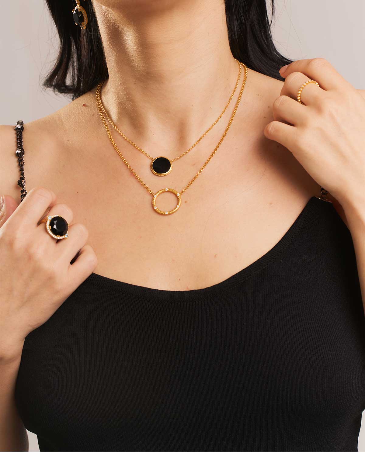 Close-up of gold necklace highlighting six round diamonds in a circular pendant