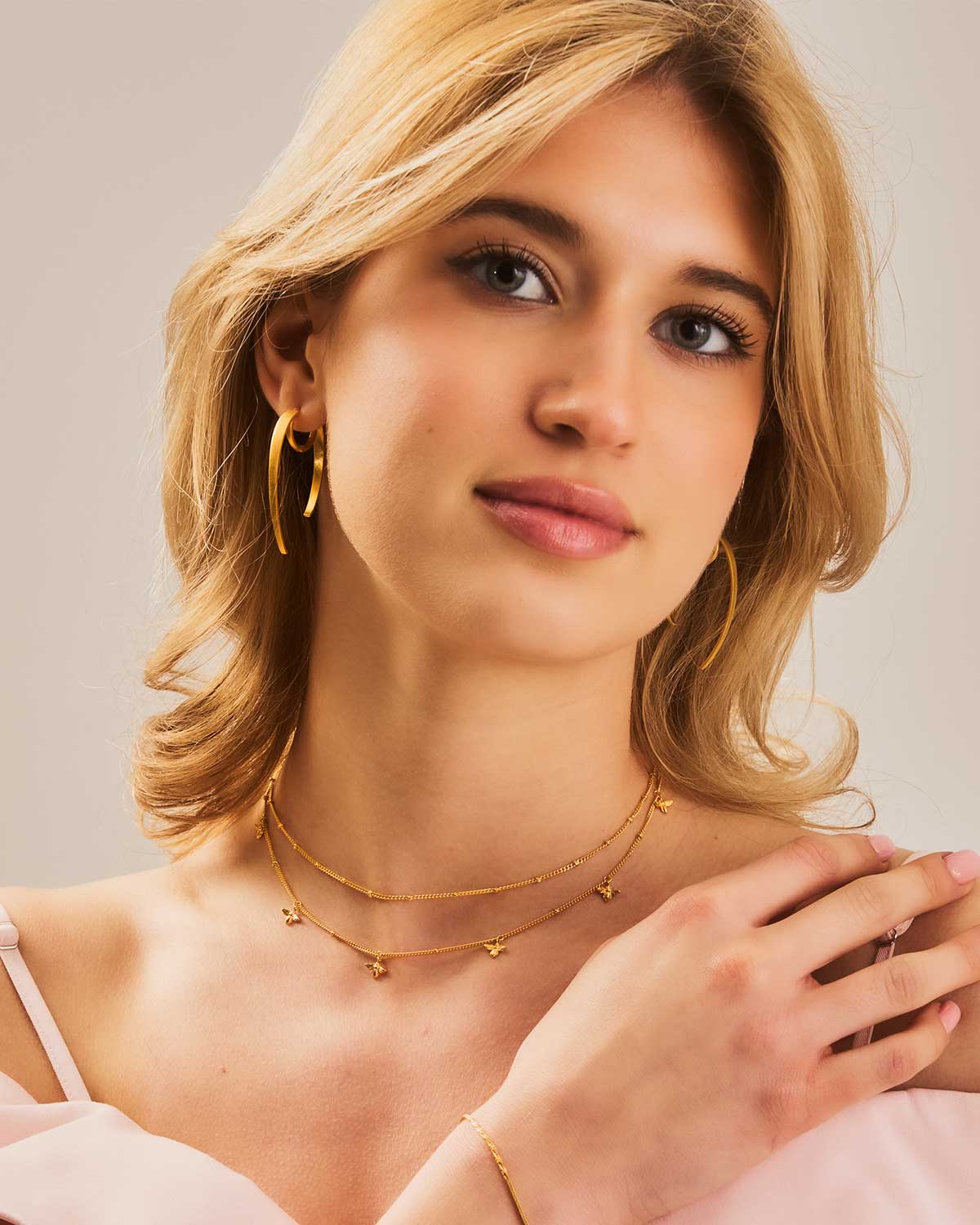 Model wearing spiky sterling silver hoop earrings, showcasing silver elegance with an edgy style