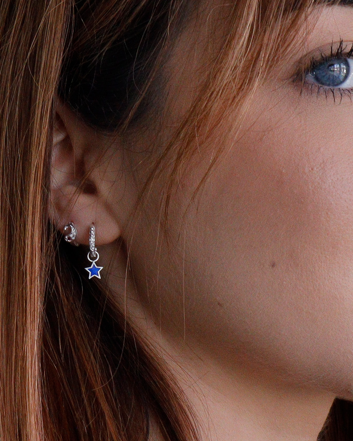 Sterling silver mini hoop earrings with removable blue and orange enamel charms