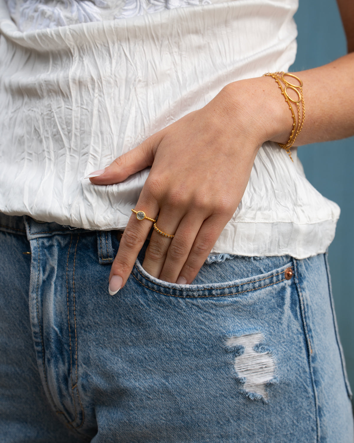Close-up of gold ring showcasing moissanite diamonds and polished finish
