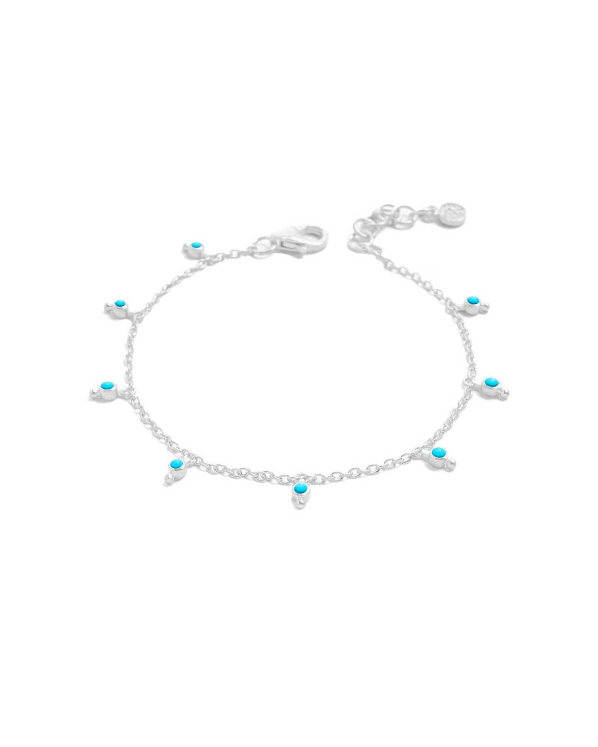 Silver bracelet with tiny turquoise gemstones and handcrafted charm details