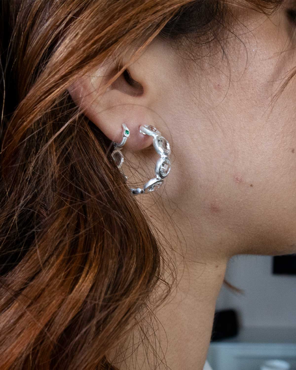 Model wearing midsize crystal silver hoop earrings