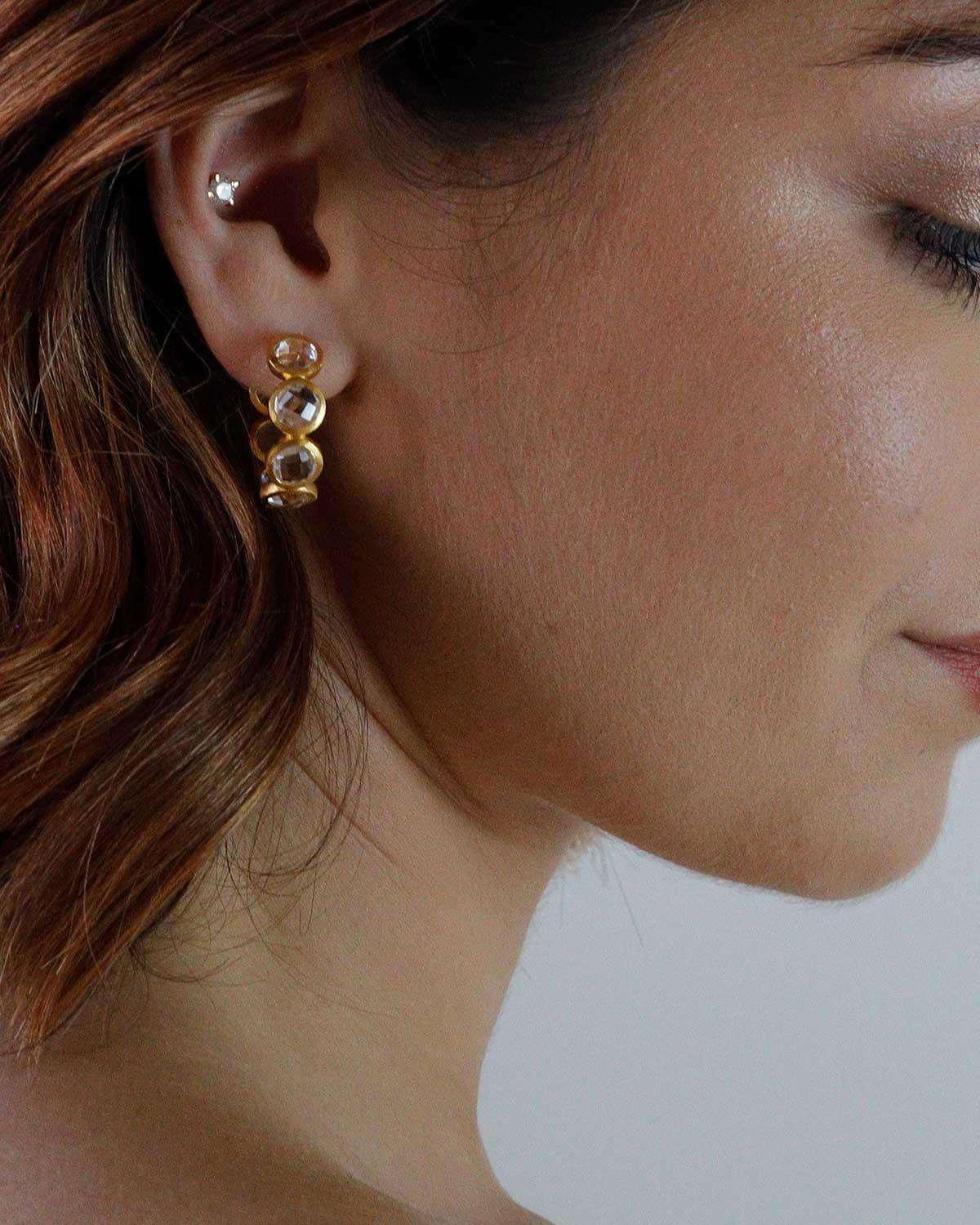 Midsize gold crystal hoops designed for everyday wear