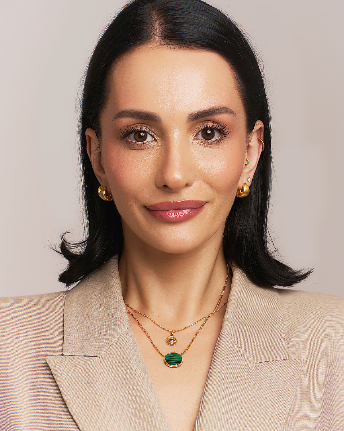 Close-up of gold necklace highlighting hand-cut malachite gemstone