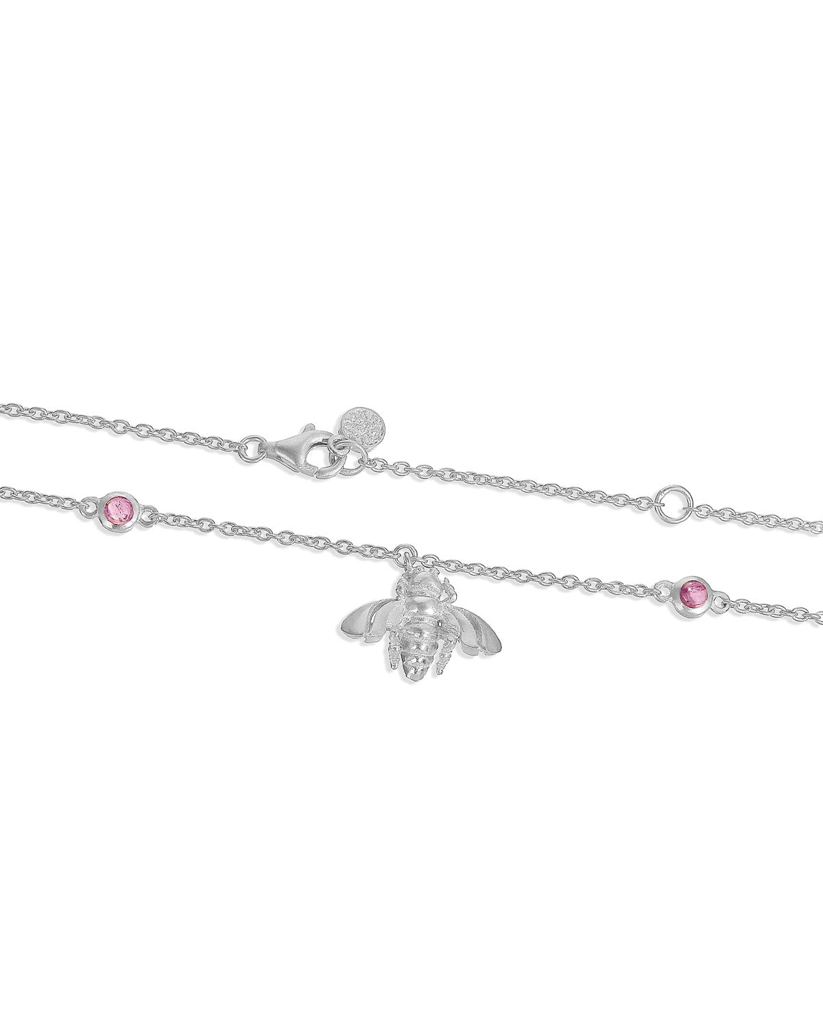 Close-up of blue topaz and pink tourmaline gemstones on silver bee pendant necklace