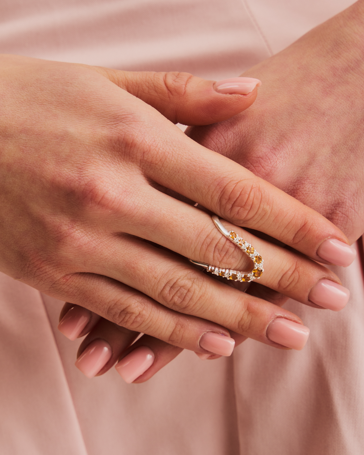 Close-up of silver ring featuring multiple citrine gemstones