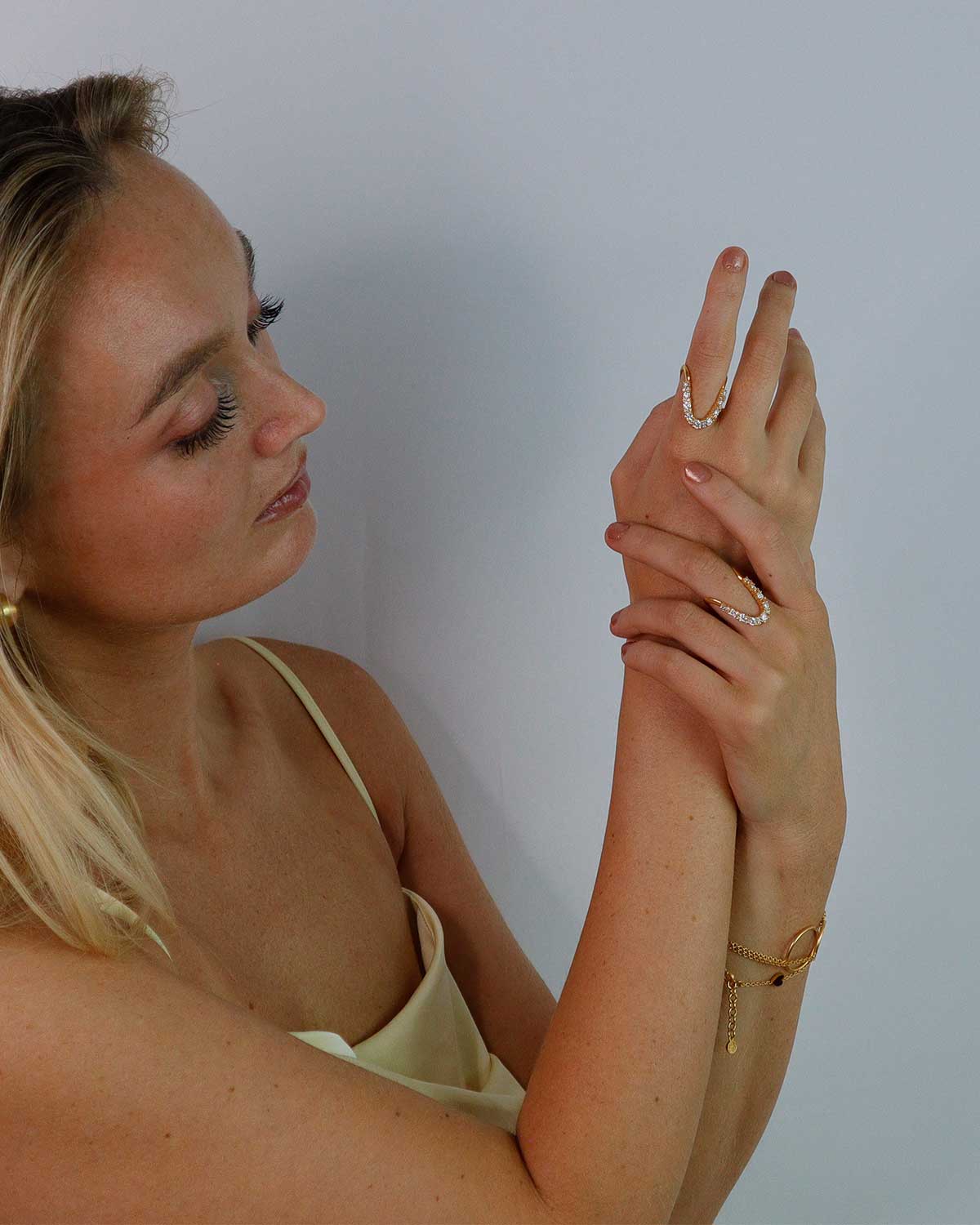 Gold ring with moissanite diamonds styled as a statement piece on the hand