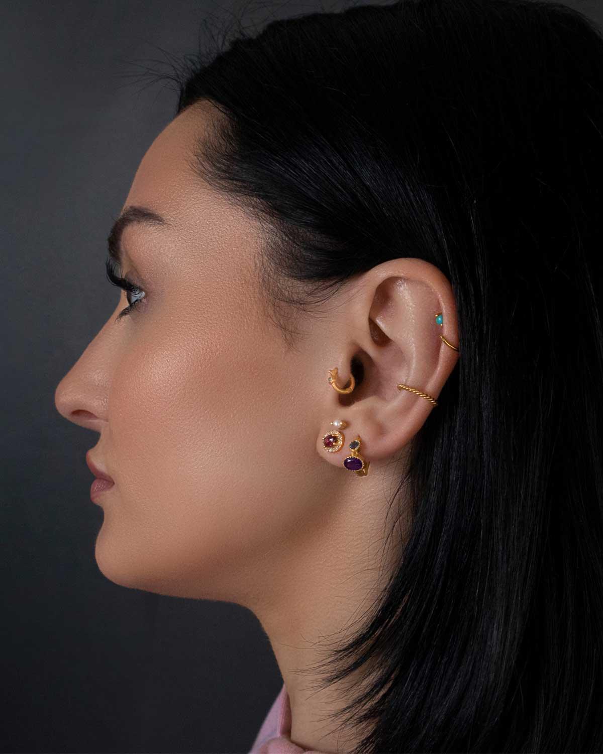 left handside closeup of model wearing a Pink Tourmaline Gold Studs, and other earrings Moon London women jewellery U.K