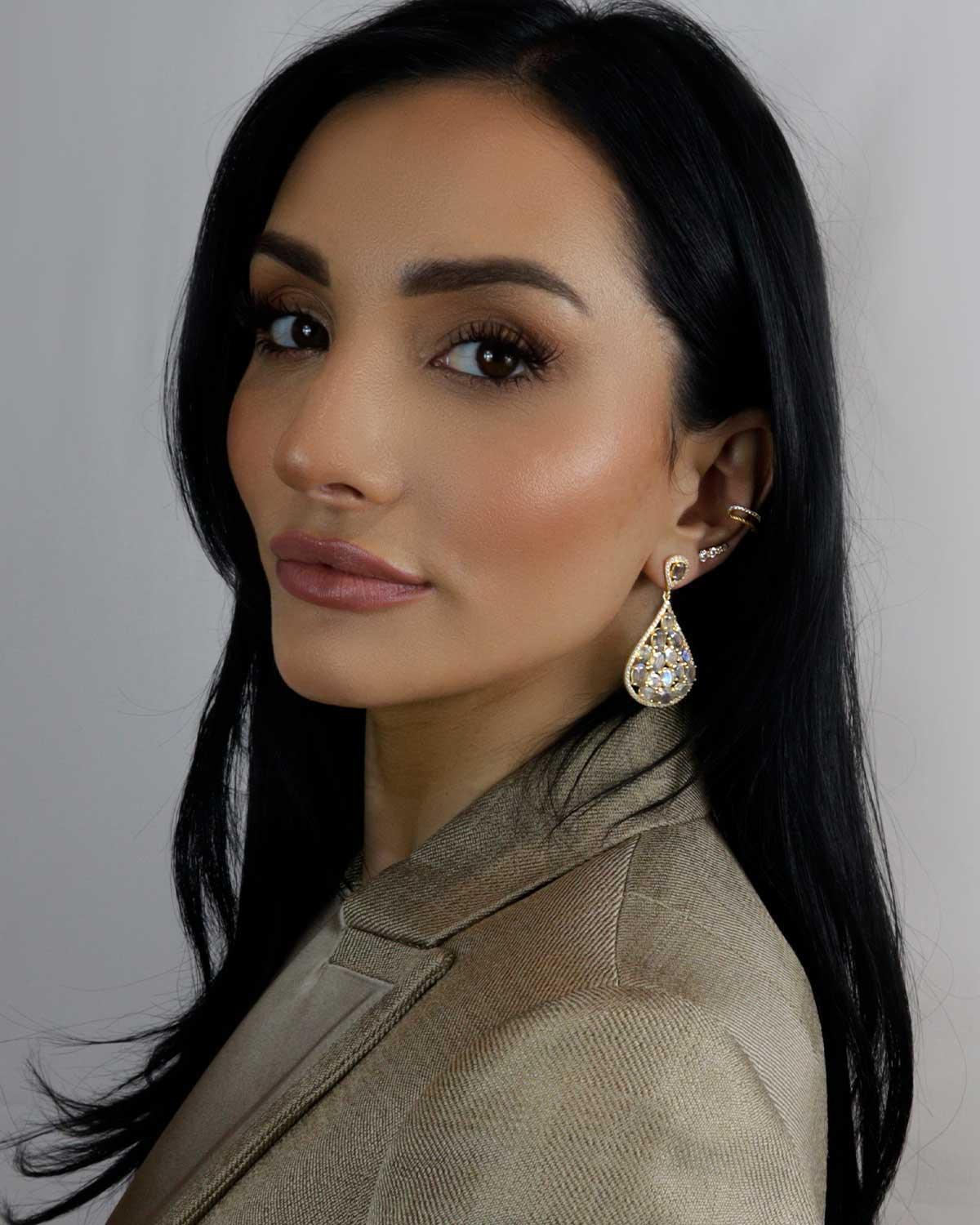 Model wearing statement silver earrings with labradorite gemstones