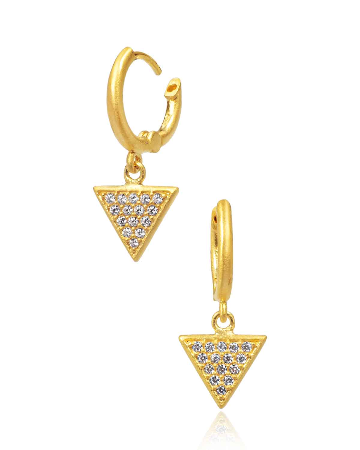 Mini hoop earrings styled in a stacked look with crystal charms