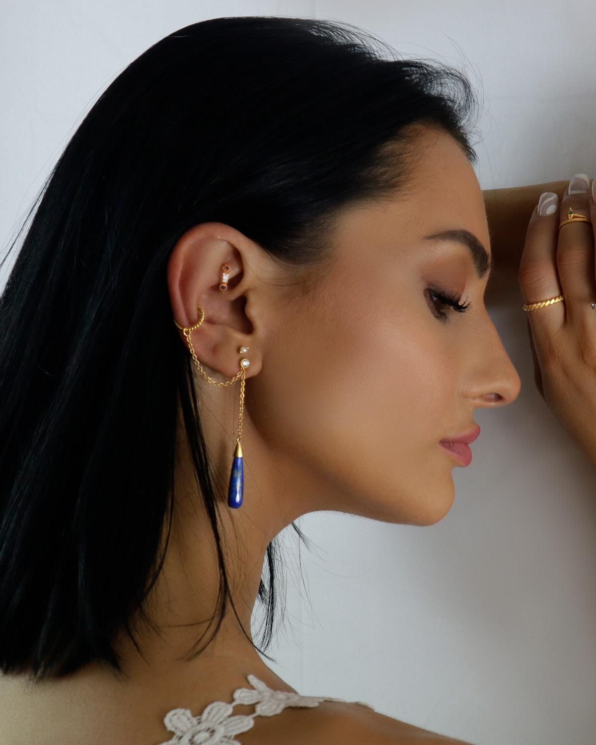 Model wearing gold vermeil earrings with lapis lazuli gemstones