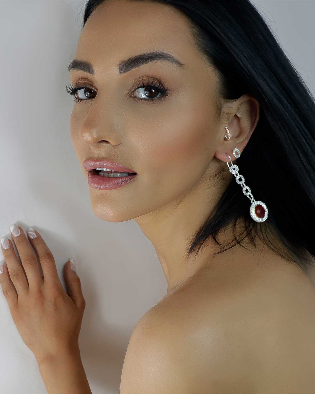 Side angle of silver drop earrings with smoky quartz gemstone details