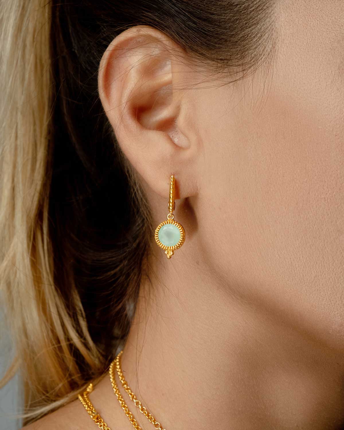 Detailed view of aqua chalcedony drop on silver mini hoop earrings