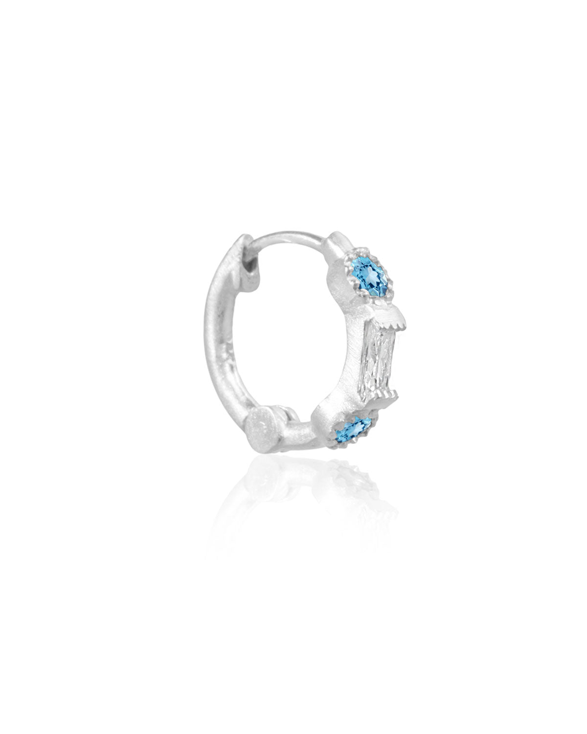 Silver mini hoops with blue topaz styled with stacked earrings