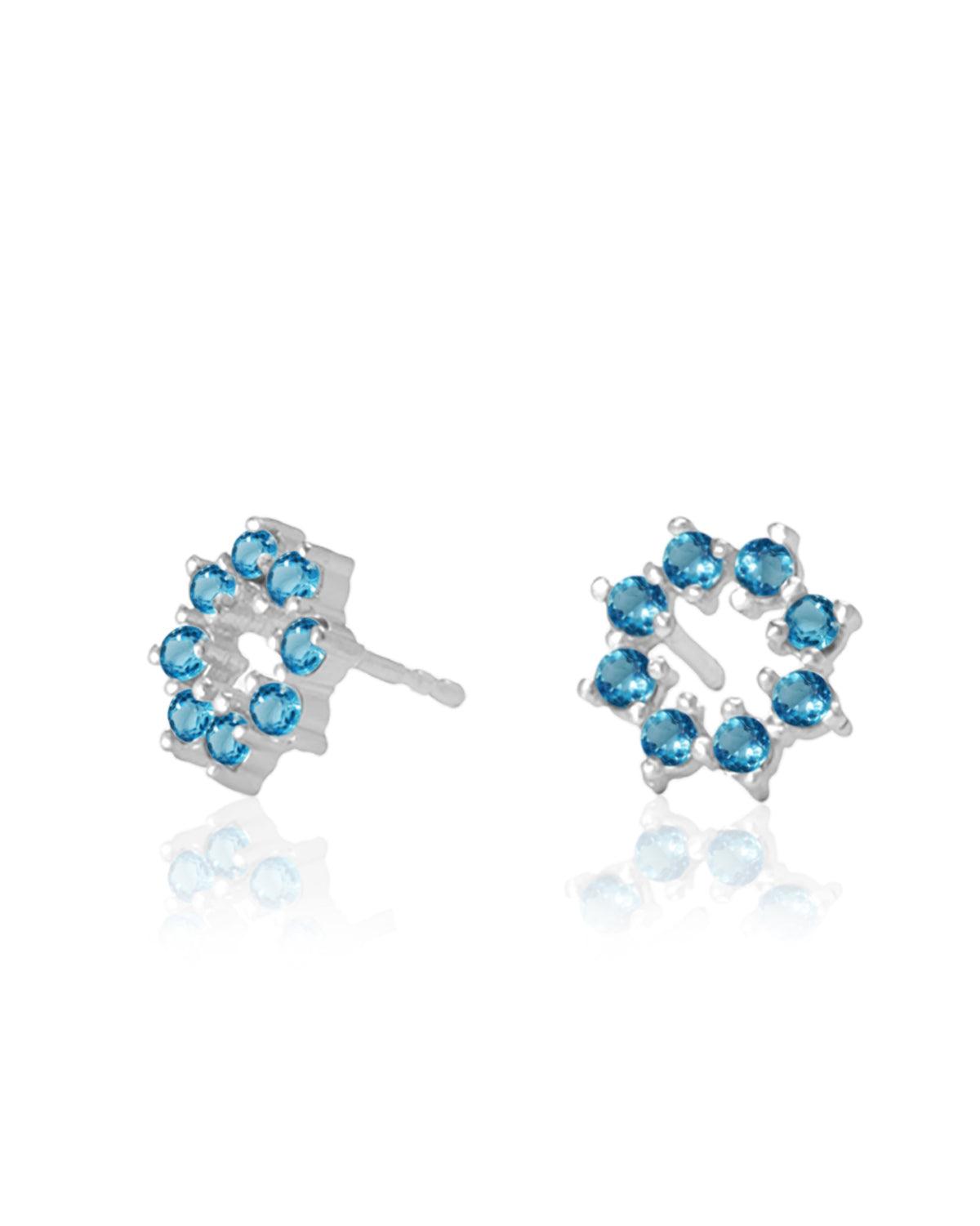 Tiny silver stud earrings with hand-cut blue topaz gemstones
