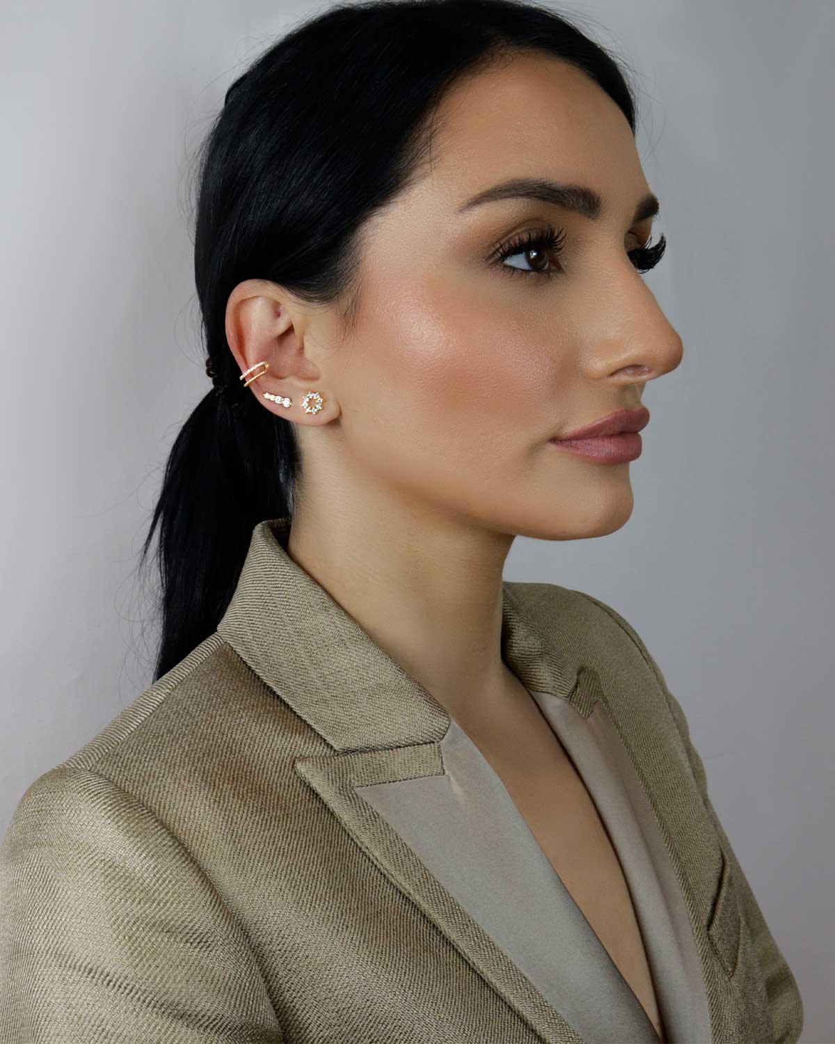 Labradorite stud earrings styled across multiple ear piercings