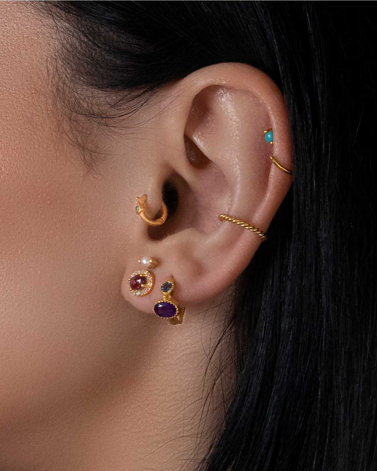 Close-up of gold mini hoops with faceted labradorite and moonstone