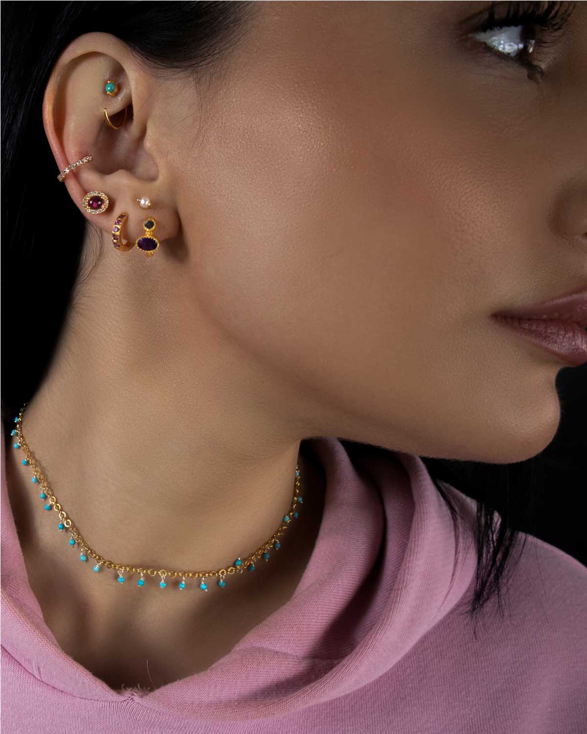 Model wearing silver mini hoop earrings with labradorite and moonstone