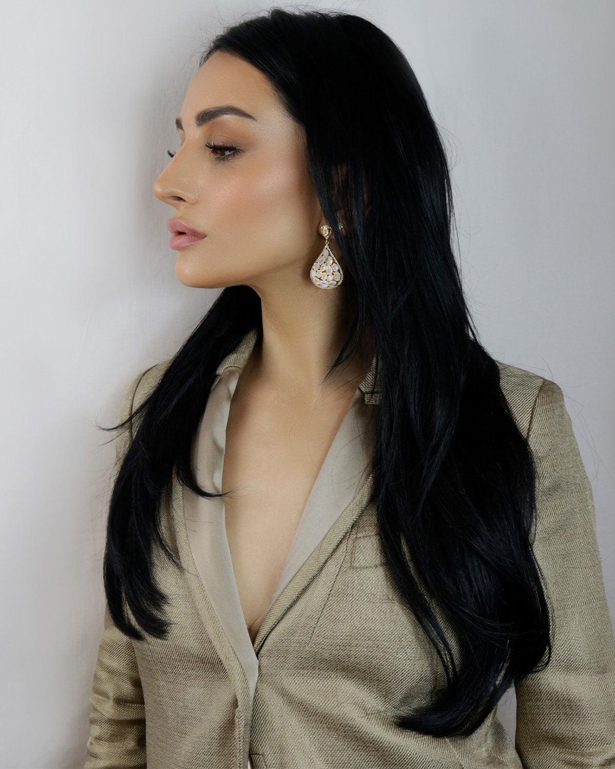 Model wearing statement silver earrings with rainbow moonstones