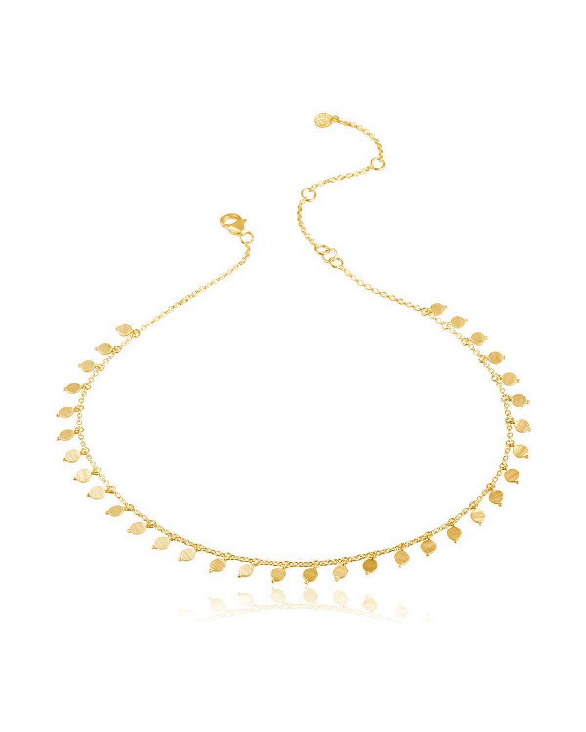 Detailed view of textured gold disks on choker necklace