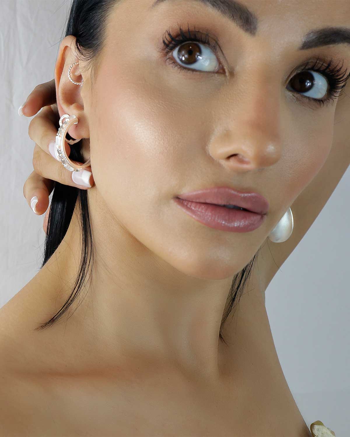 Model wearing midsize silver hoops with mixed gemstones