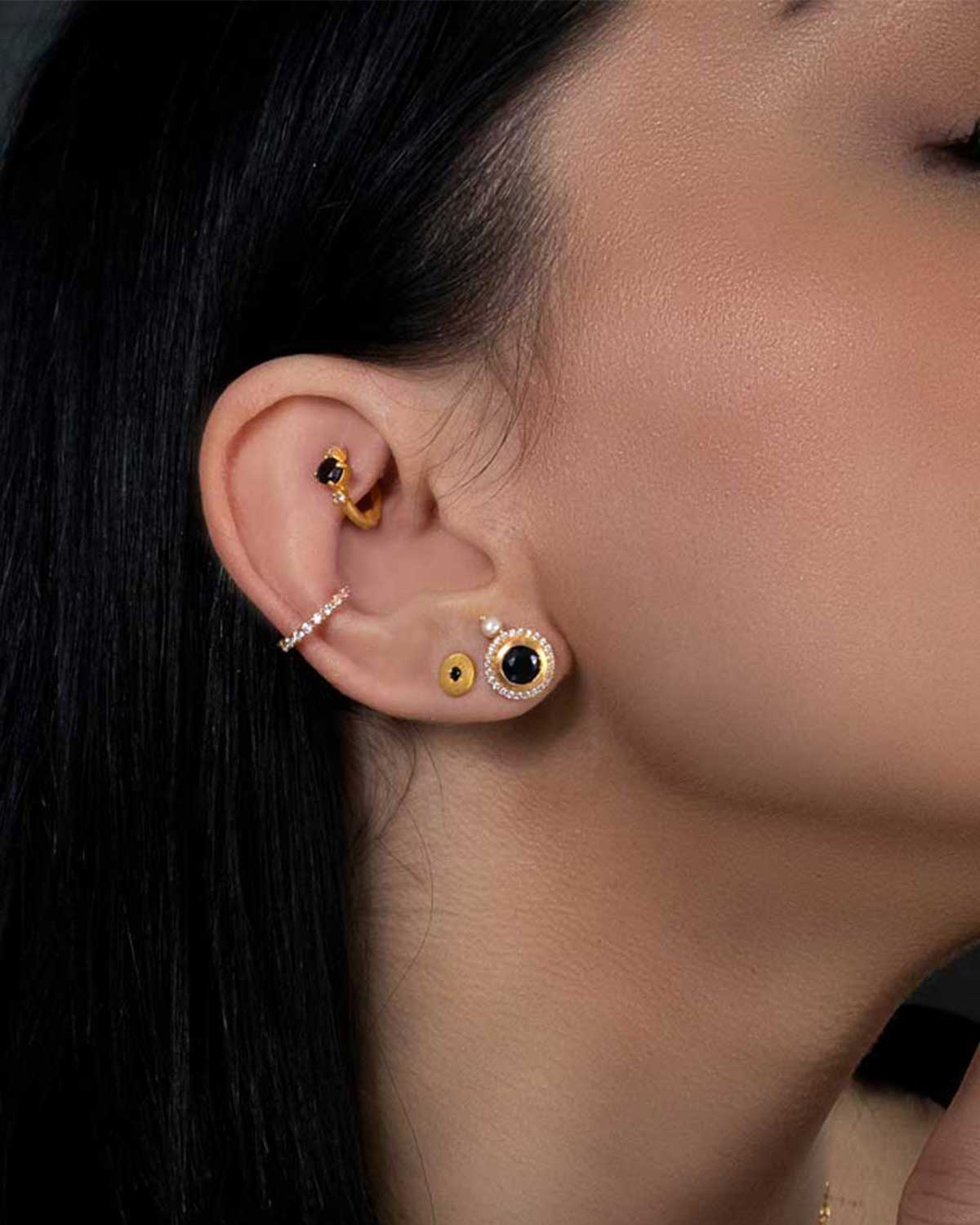 Close-up of silver mini hoops with black spinel and organic pearls