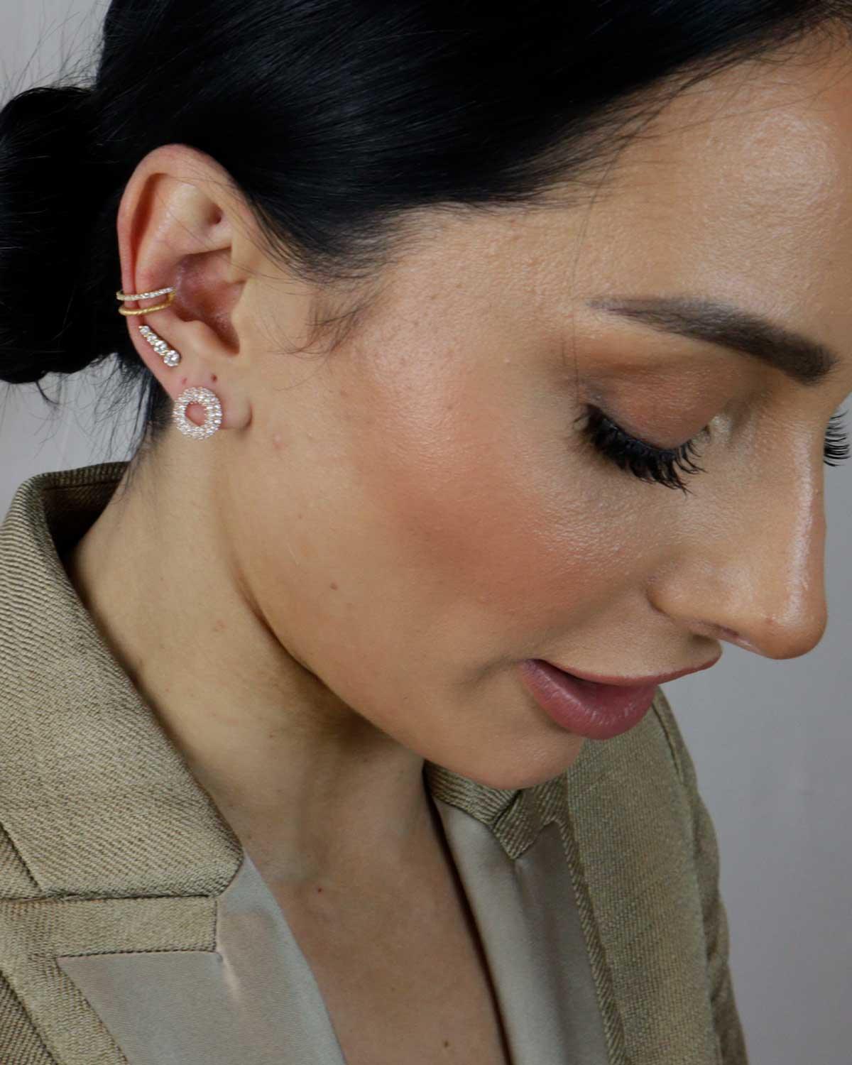 Close-up of round gold studs featuring AAA cubic zirconia stones