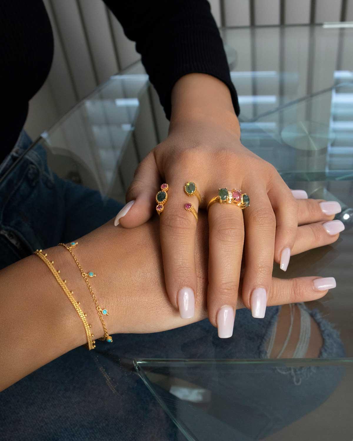 Model wearing silver bracelet with turquoise gemstones