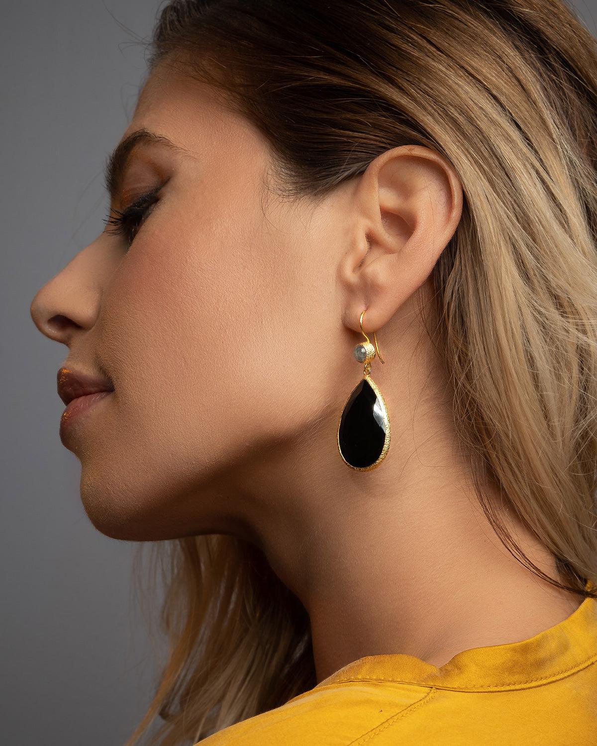 Close detail of teardrop silver earrings with black spinel gemstone